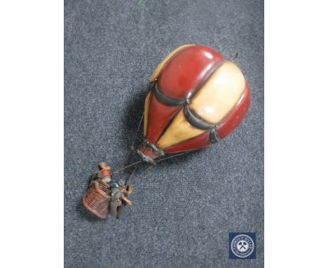 A wooden hanging model of a hot air balloon 