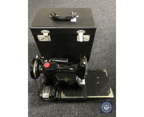 A cased vintage Singer sewing machine