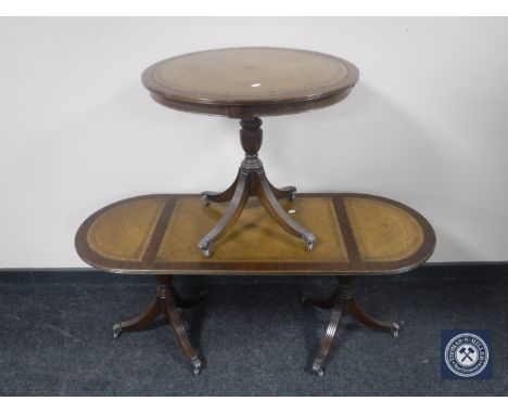 A mahogany pedestal occasional table with a tooled leather panel and oval coffee table 