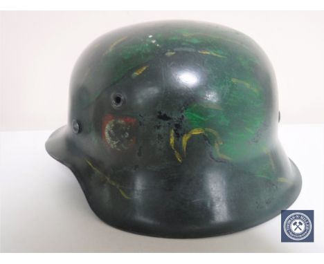 A German Third Reich M42 helmet, with later SS and Swastika decals, the underside stamped 557
