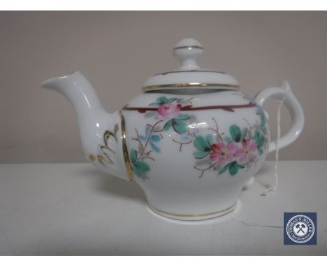 An antique hand painted Meissen style teapot with blue crossed swords to base and numbered in puce 5129, height 9 cm.