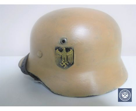 A German Third Reich M35 helmet, later painted, with single eagle decal, the underside stamped 4730 and Q64