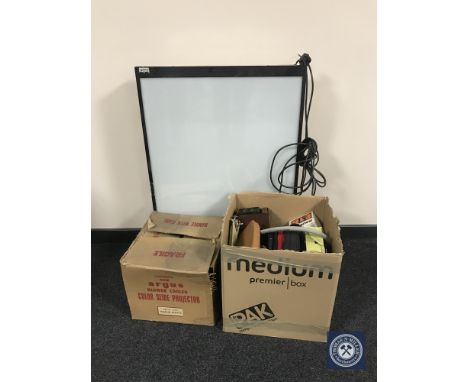 A large photographic light box together with two boxes containing a Hanimex projector, assorted cameras and accessories