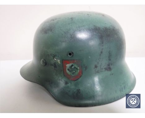 A German Third Reich M42 helmet, with later SS and Swastika decals, the underside stamped 616