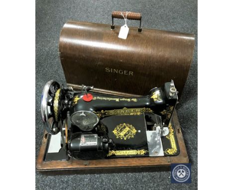 A vintage oak cased Singer sewing machine