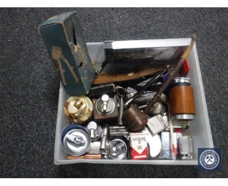 A box containing assorted table lighters and pocket lighters, penknives, hunting knife in sheath, vintage razor etc