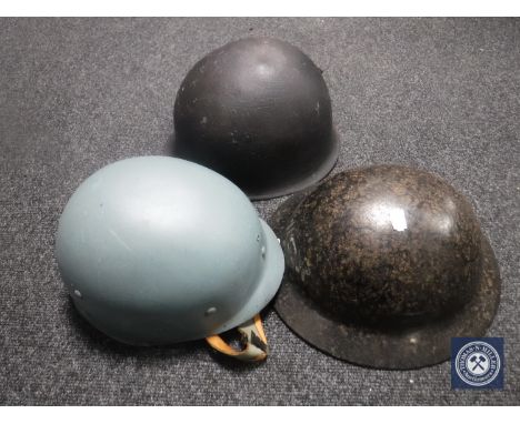 A post-war American helmet together with two other helmets
