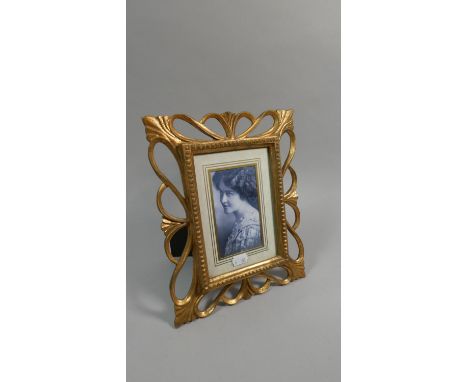 A Reproduction Gilt Framed Easel Backed Photo Frame with Pierced Border 