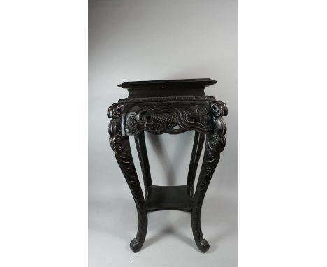 An Oriental Ebonised Vase Stand with Carved Decoration Depicting Carp in Reeds, Extended Cabriole Legs and Stretcher Shelf, 7