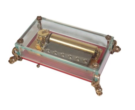 REUGE SAINTE-CROIX SWISS MUSIC BOX, the 11cm cylinder playing three aires, housed in a crystal glass case, with brass dolphin