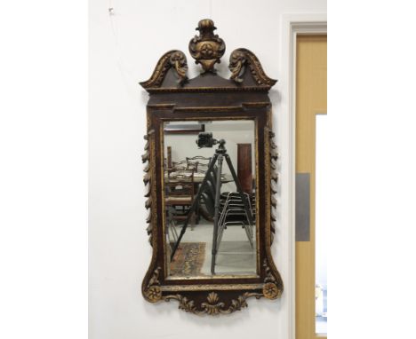 GEORGE II STYLE MAHOGANY AND GILTWOOD WALL MIRROR, the bevelled plate within a carved "egg and dart" outer frame, with broken