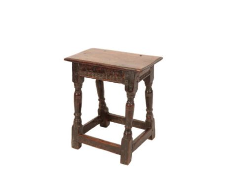 CHARLES II OAK JOINT STOOL, LATE 17TH CENTURY, the rectangular top with a moulded edge above a carved frieze, raised on turne