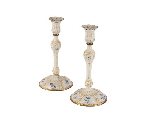 PAIR OF GEORGE III ENAMEL CANDLESTICKS, 18TH CENTURY, of baluster form painted with blue flower studies against gilt enriched