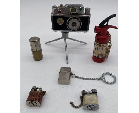 A vintage KKW novelty camera lighter on tripod along with 5 miniature lighters
