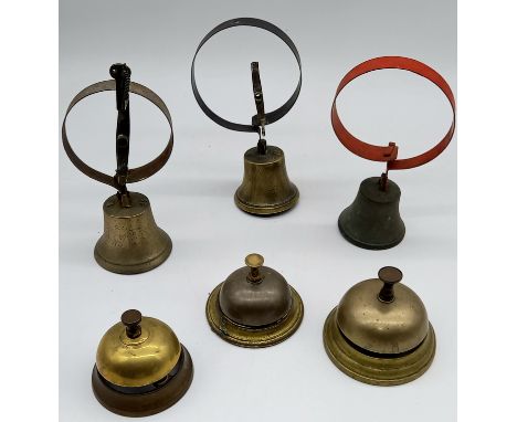 A collection of antique and vintage brass shop and table bells.