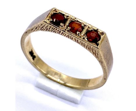 A 9ct gold garnet three stone ring, weight 1.7g, size M