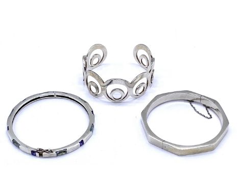 An octagonal 925 silver bangle along with one other and a silver bangle set with gemstones- clasp loose but present