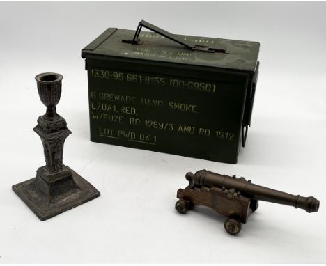 A vintage green painted ammo box along with a desktop cannon and silver plated candlestick