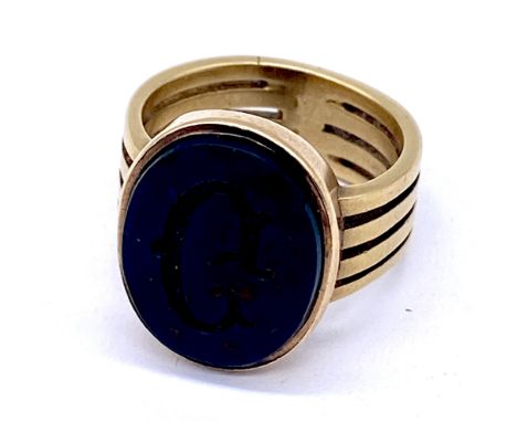 An 18ct gold (tested) signet ring set with a monogrammed bloodstone, size K, gross weight 7.5g