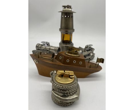 Five novelty table lighters including a miners lamp, cannon, wooden boat, motor car etc