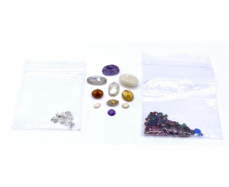 A collection of loose gemstones including amethyst, opal etc.