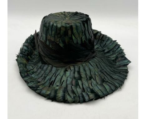 A vintage ladies green feather hat along with mismatched hatbox (A/F)