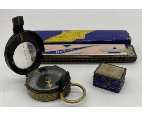 A WWI era military compass with broad arrow stamp, serial number 48462 along with a boxed Hohner Echo-Luxe harmonica and an O