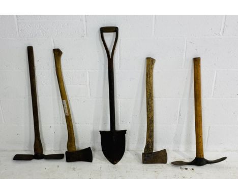A collection of five tools including two pickaxes, spade and two axes