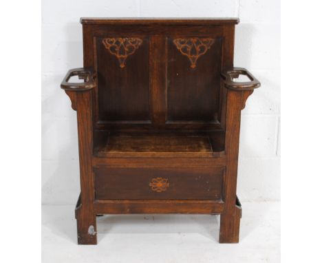 An oak hall seat, with stick stands either side and lift up seat revealing storage, with carved detailing