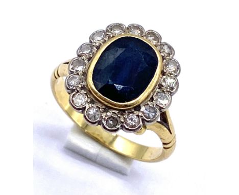 An unmarked 18ct gold sapphire and diamond cluster ring, the oval sapphire measuring approx. 9 x 7mm, size N