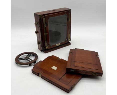 An A J Lancaster & Son mahogany and brass antique camera with two additional plates, manufacturer's label for A.W. Yablsey, B