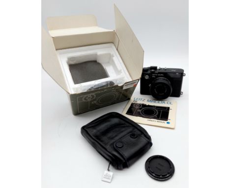 A black Leitz Minolta CL 35mm rangefinder camera, camera body serial number 1035004, with case and original box.