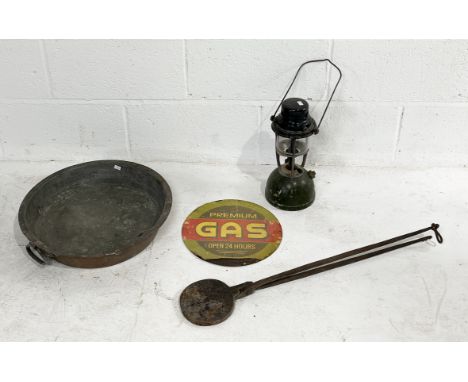 A collection of metalwork items including copper pan, waffle iron, Tilley lamp and vintage gas sign