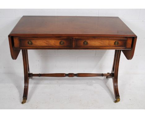 A reproduction drop-leaf sofa table, with two drawers - length 104cm (extending to 152cm), depth 56cm, height 74.5cm