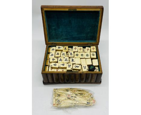 A vintage bone Mahjong set in wooden storage box