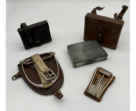 A collection of leather cased hunting items including a sandwich box, replacement Champion & Wilton stirrup, nickel plated mu