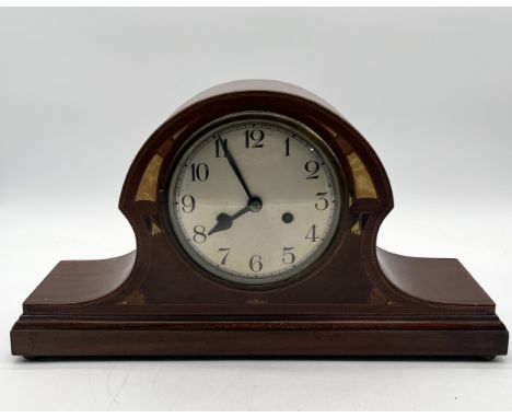 An oak cased mantle clock by Baduf with inlaid detail to front