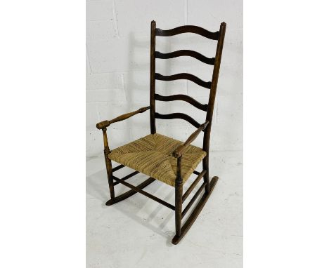 A Vintage ladder-back rush seated rocking chair, 55cm wide, 43cm deep, 105cm high.