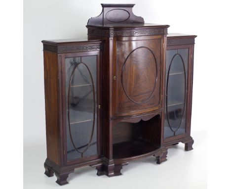 A Chippendale style mahogany Breakfront Display Cabinet, of low proportions, the raised central section with panel door flank