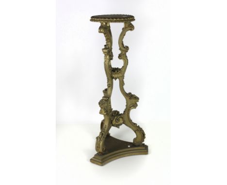 A 19th Century carved giltwood Torchere in the Chippendale style, the moulded circular top over three C scroll supports, embe