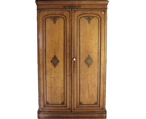 An Aesthetic period stained oak two door Wardrobe, the painted and moulded top over two panel doors with similar decoration o