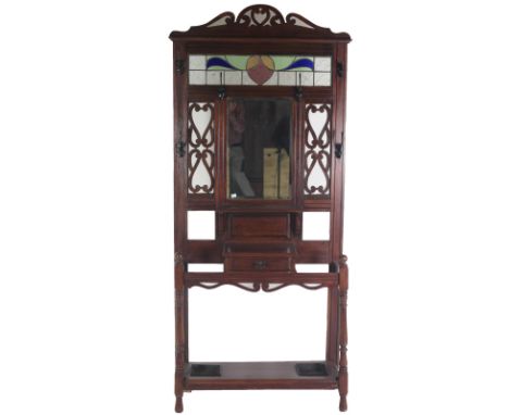 An Arts & Crafts period mahogany Stick and Umbrella Stand, in the style of Voysey, with attractive stained glass panel inset,