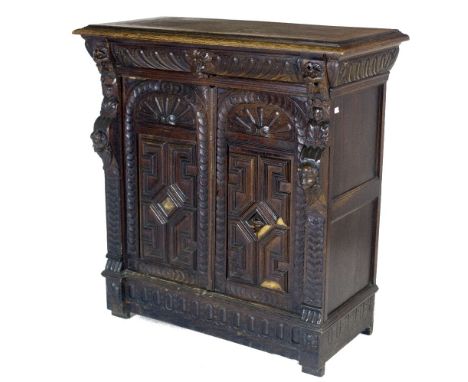 A 19th Century oak Cromwellian style Larder Press, with moulded top over a frieze drawer with grotesque masks, over carved pa