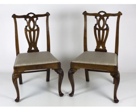 A good pair of early 19th Century carved Irish walnut Side Chairs, in the Chippendale style, with attractive splat backs over