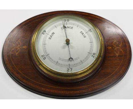 An Edwardian circular Barometer, mounted on an oval inlaid mahogany panel. (1)