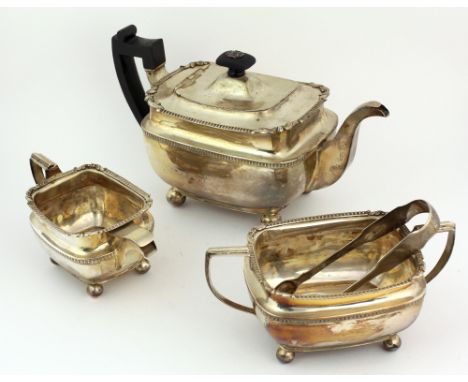 A large late George III Irish silver Tea Service, teapot (with wooden handle) cream jug and sugar bowl, with gadroon borders 