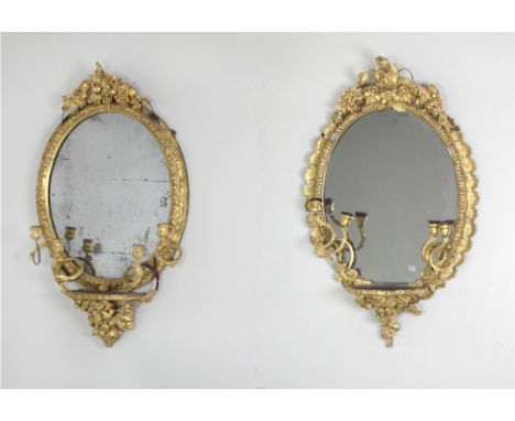 An almost matching pair of Georgian period four branch giltwood Girandoles, the frames decorated with flowers and fruit over 