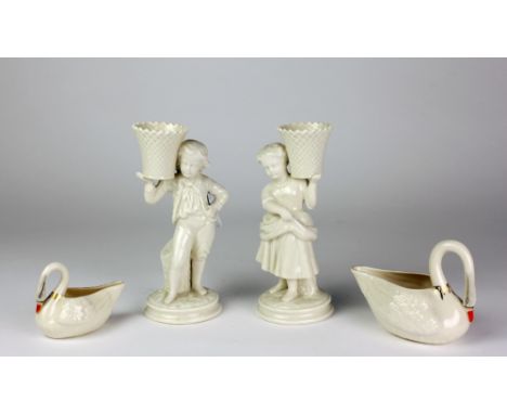 A pair of attractive cream ware Belleek 6th period mark Figures, of a young girl and boy with baskets held aloft, each approx