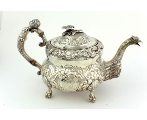 An important heavy late George III Irish silver Teapot, by James Le Bas, Dublin c. 1818, the body heavily embossed and engrav