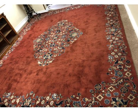 A fine quality heavy pile rust ground Donegal Carpet, with floral border and similarly designed floral diamond centre, approx